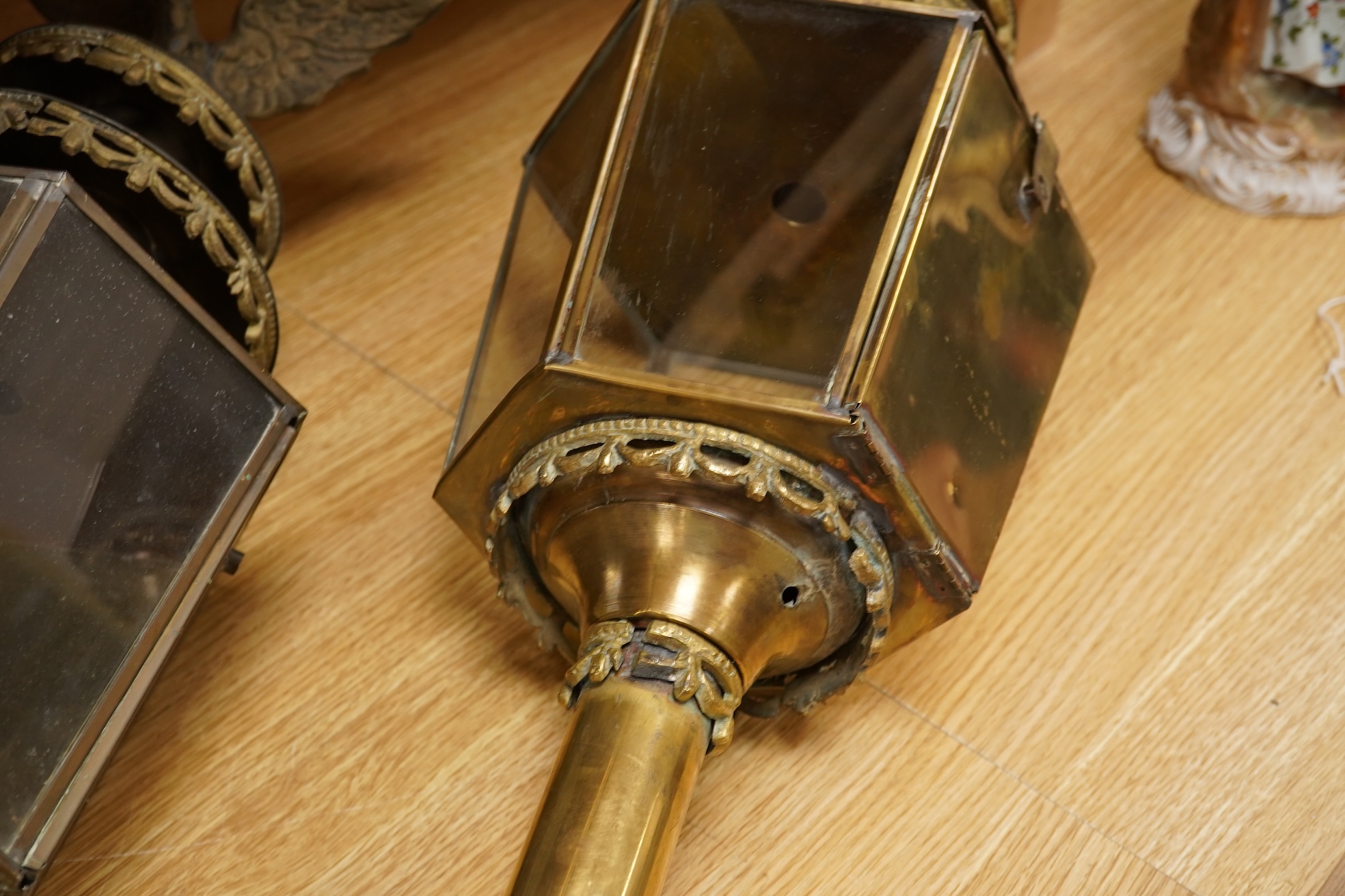 A pair of brass coaching lamps with eagle mounts, 75cm high